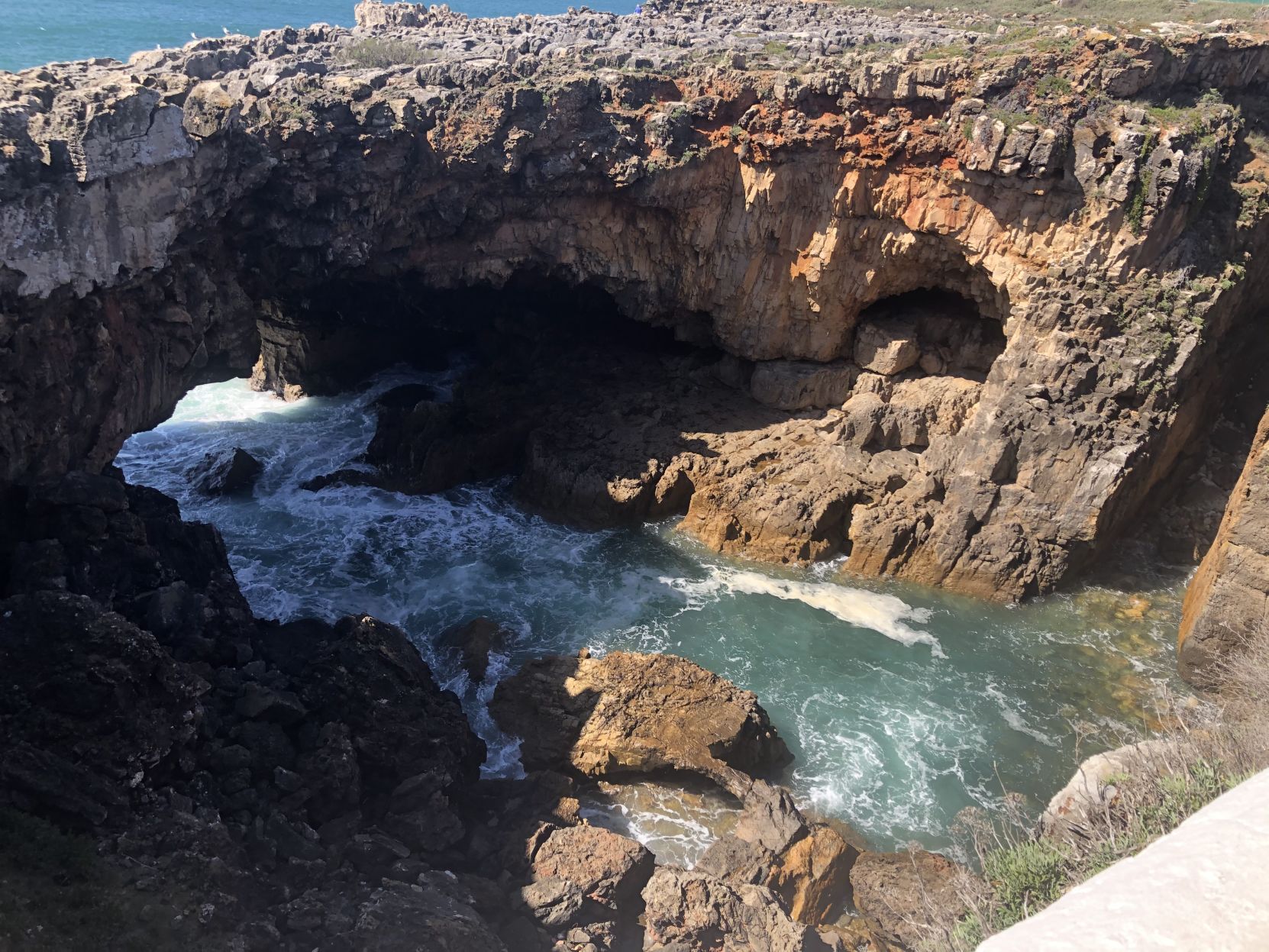 Boca do Inferno in Portugal is a raging river surrounded by rocky cliffs